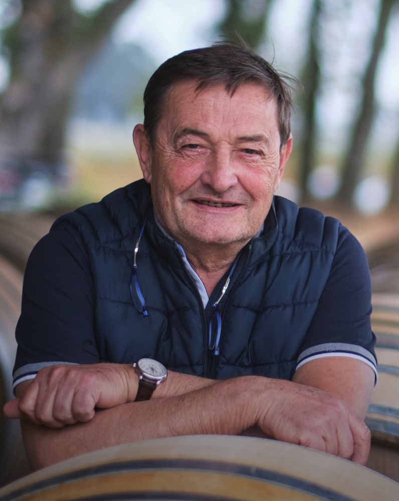 Dominique Lafon sitting outdoors with blurred trees in the background