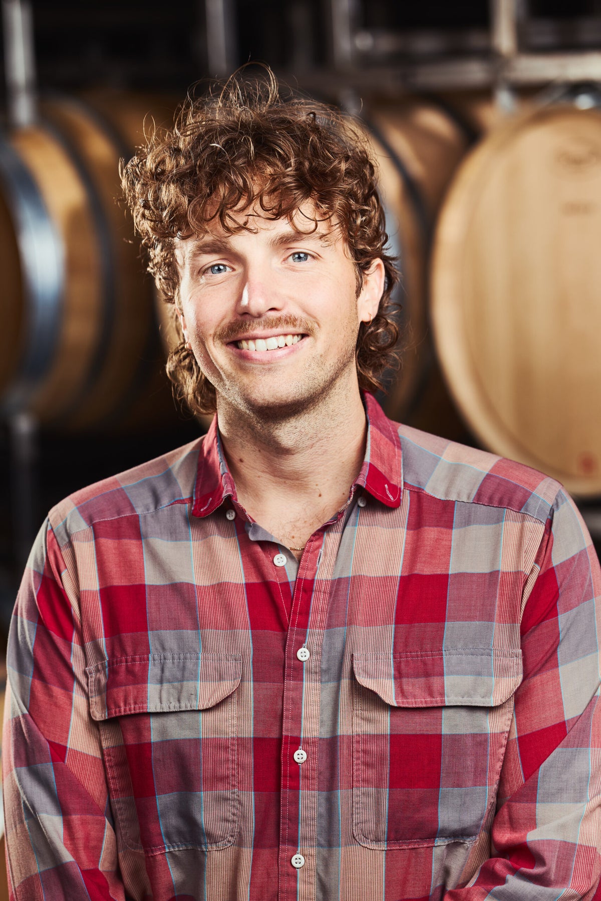 Ben Crane Cellar Operator headshot in front of wine barrels
